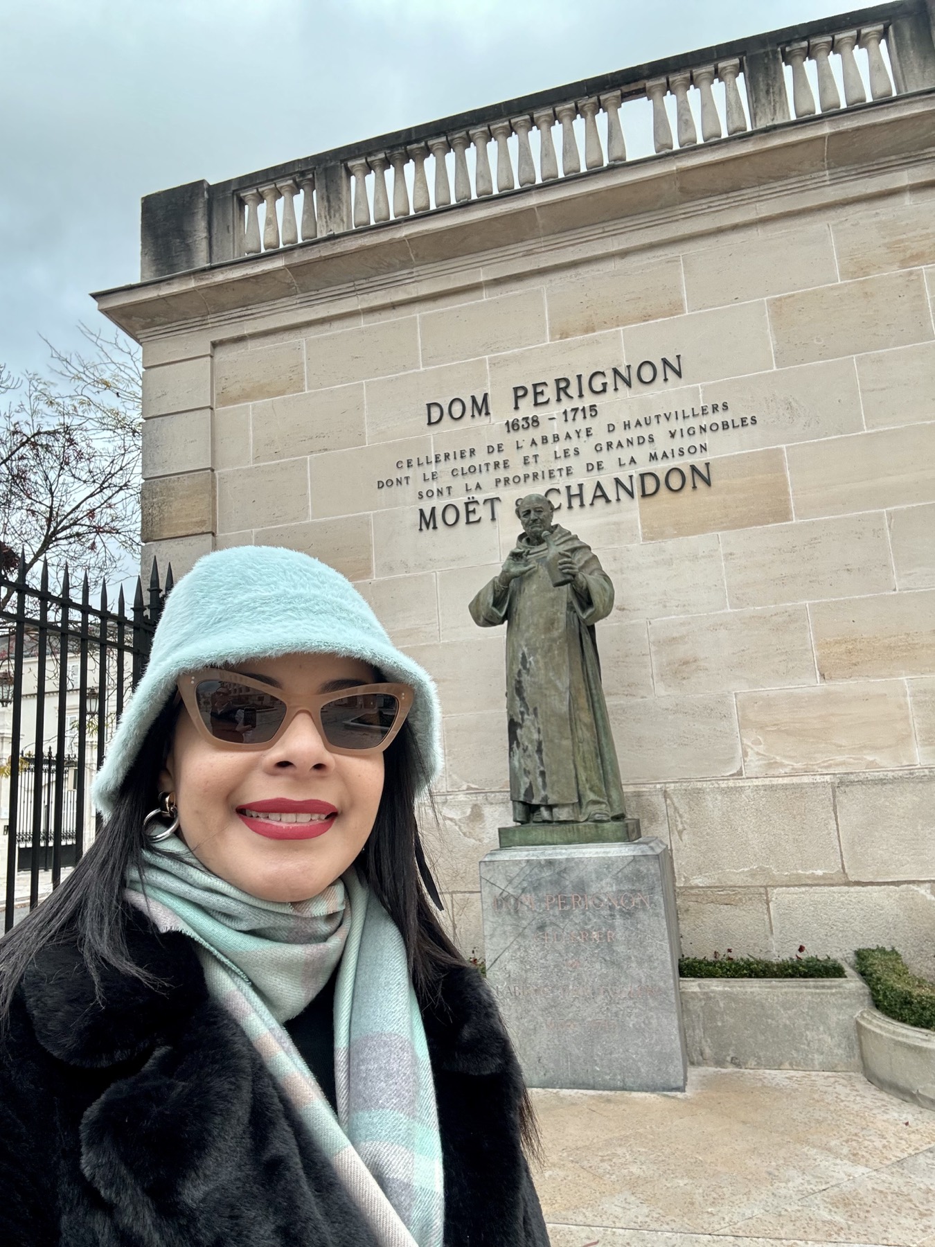 Eliza beside the Dom Pérignon statue at Moët & Chandon