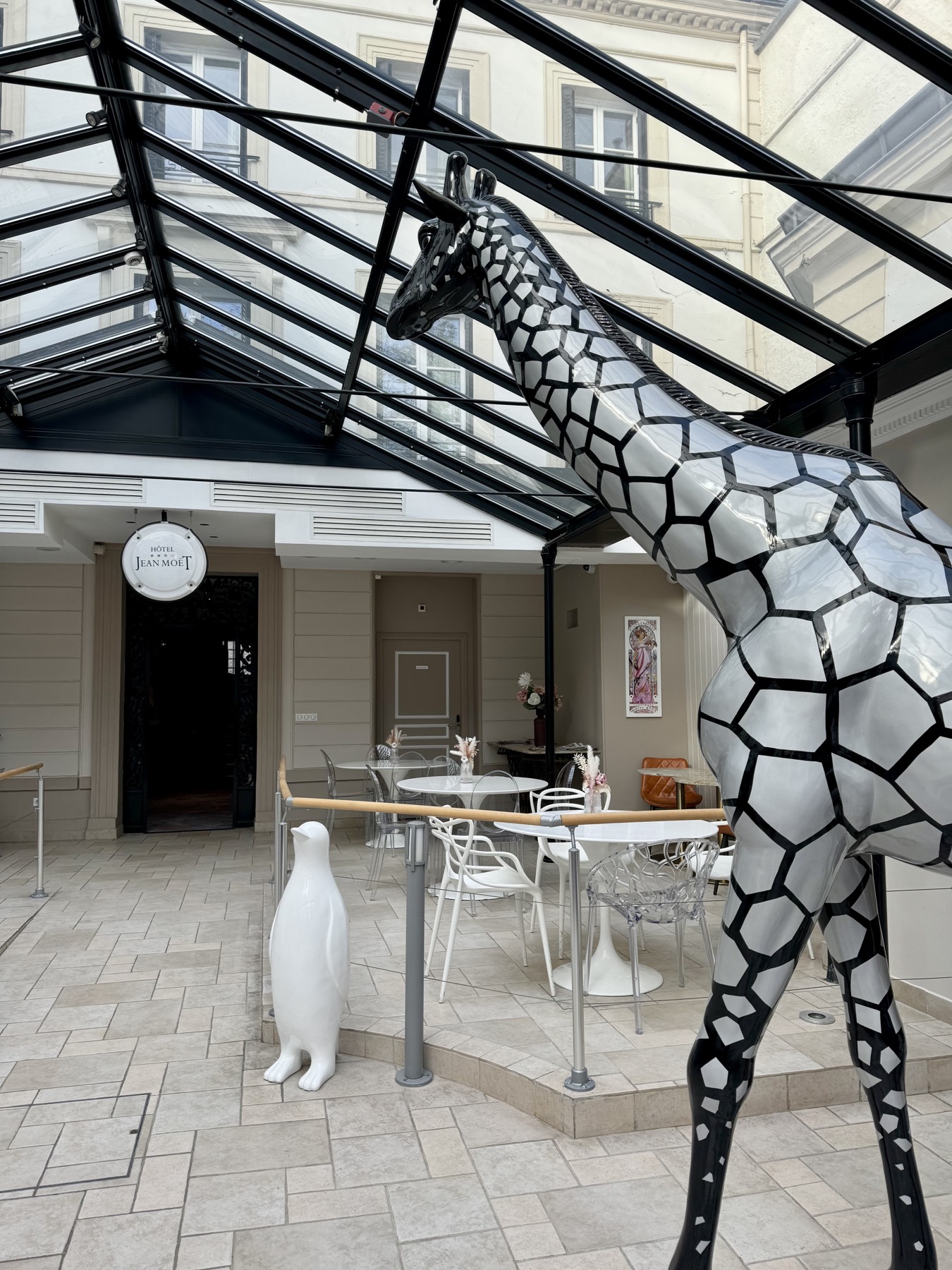 The glass-roofed courtyard at Hôtel Jean Moët
