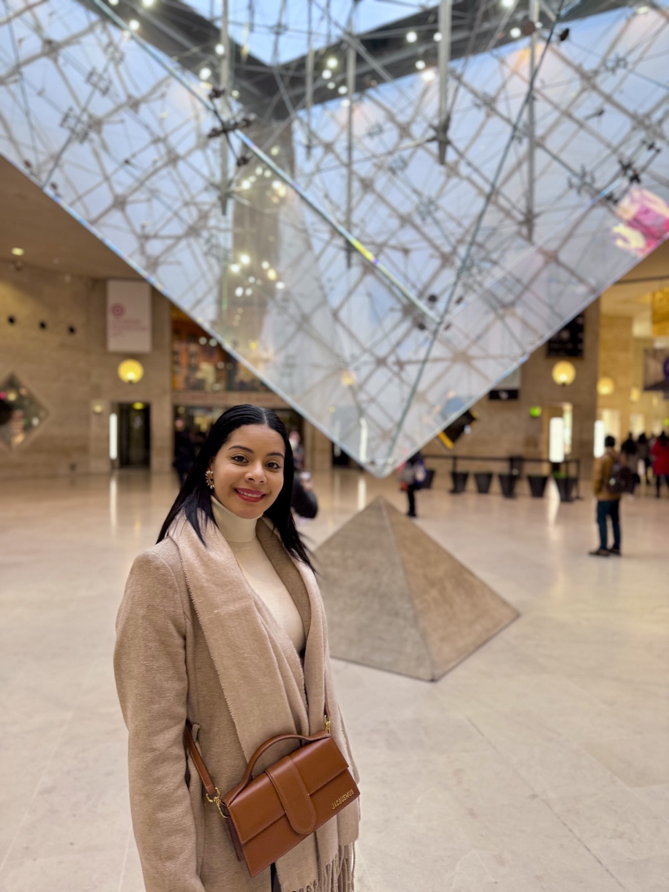 Eliza inside the Louvre beneath the inverted glass pyramid